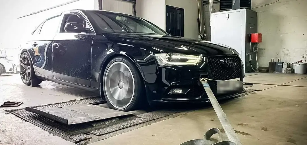 Black Audi A4 strapped down on the dyno