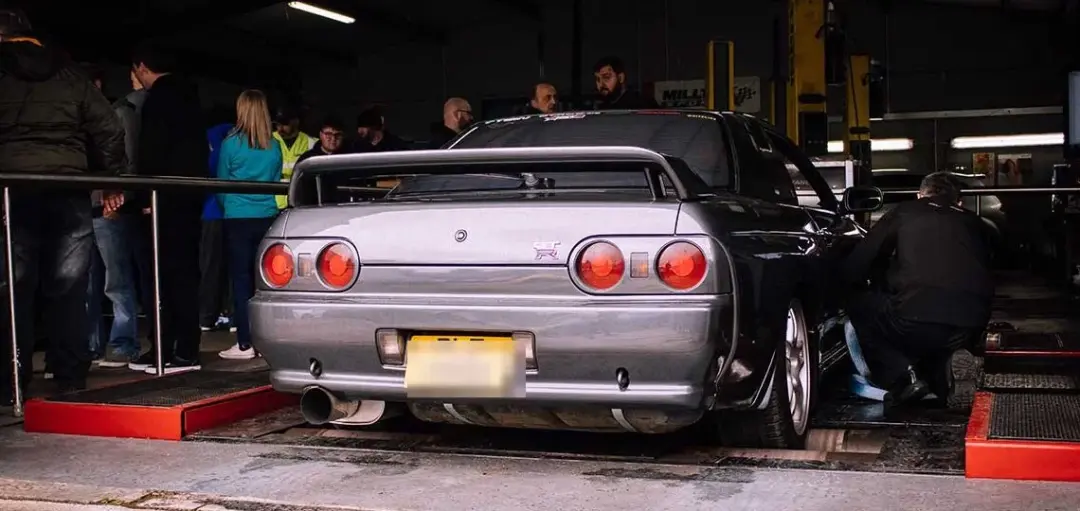 Silver Nissan Skyline GT-R on the rolling road with onlookers